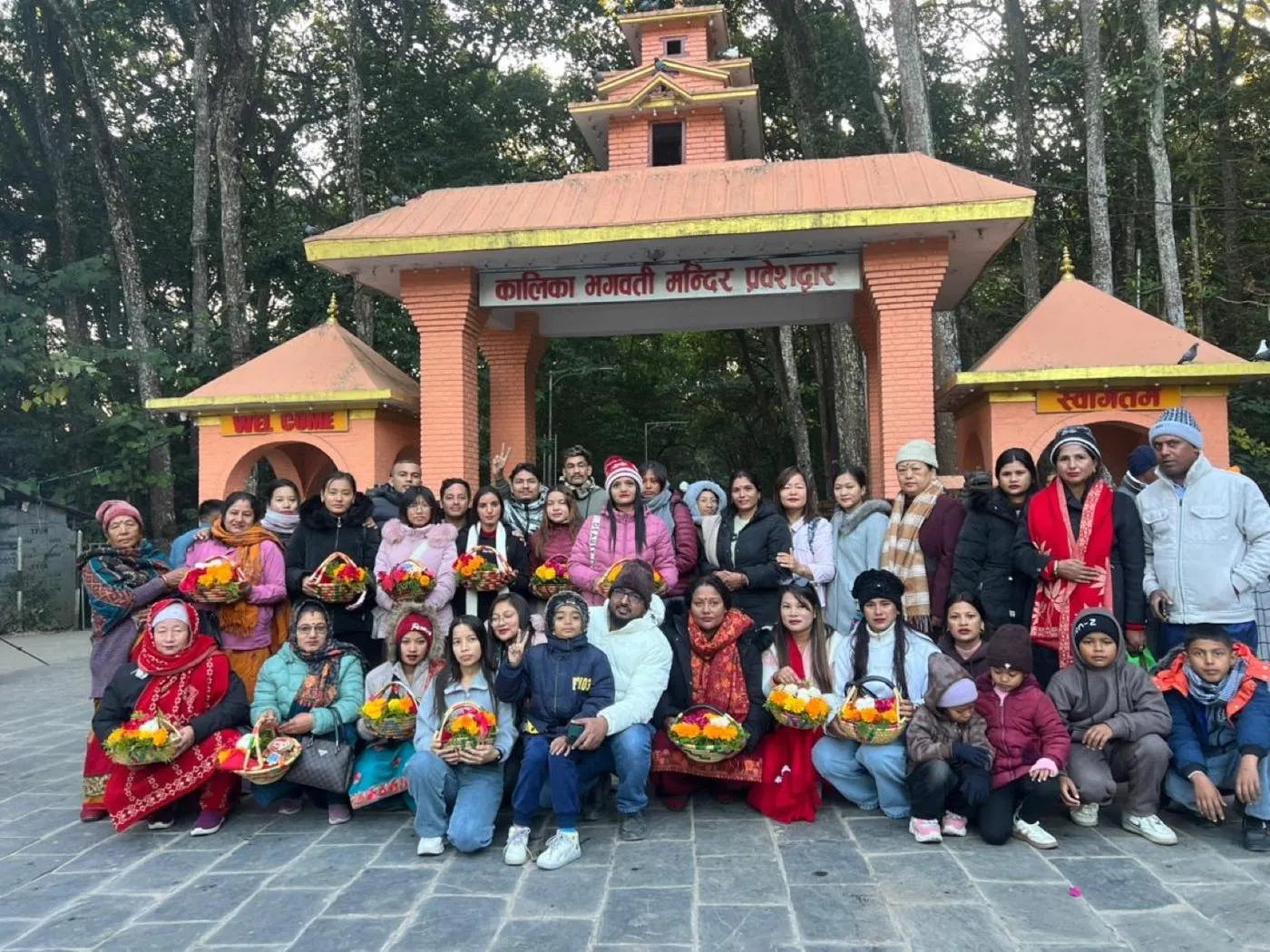 The Trishakti Apparel team at the Kalika Bhagwati temple gate in Chitwan, Nepal