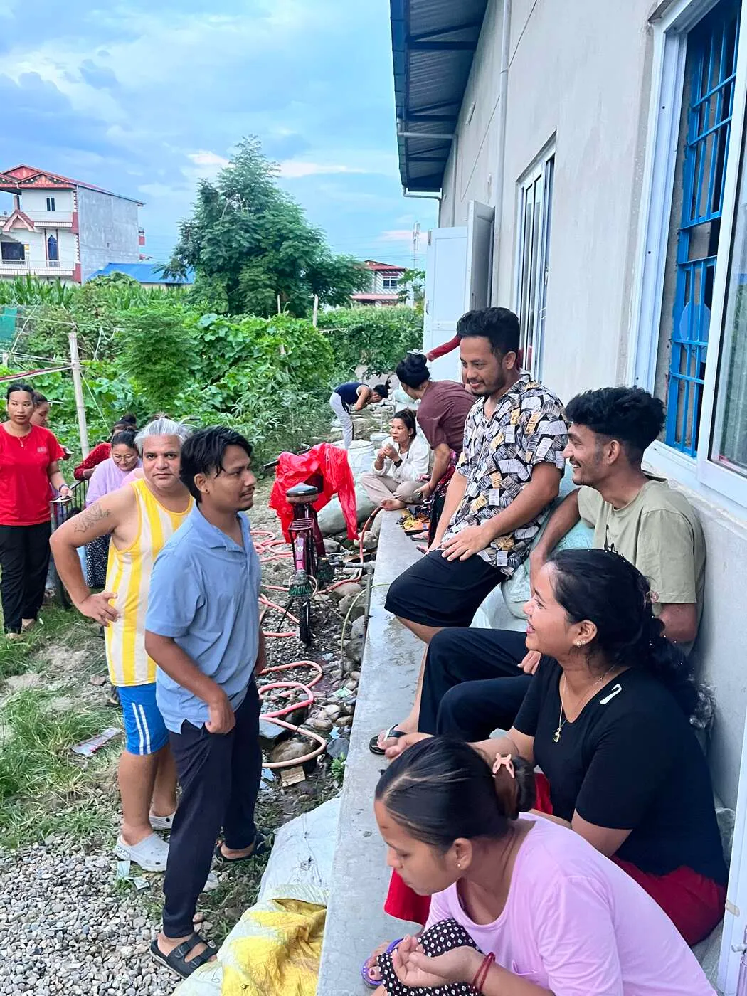 Trishakti Apparel staff and families gathered on the factory grounds in Gaindakot