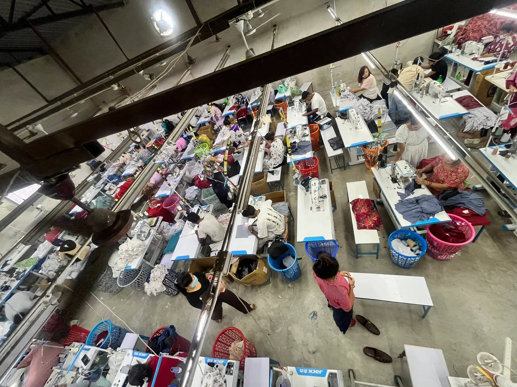 The Trishakti Apparel sewing floor in Gaindakot, Nepal, seen from above — rows of JACK machines with operators at work