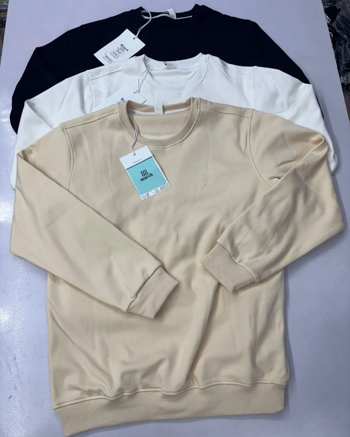 Private-label women’s fleece sweatshirts in grey, cream, pink and black
