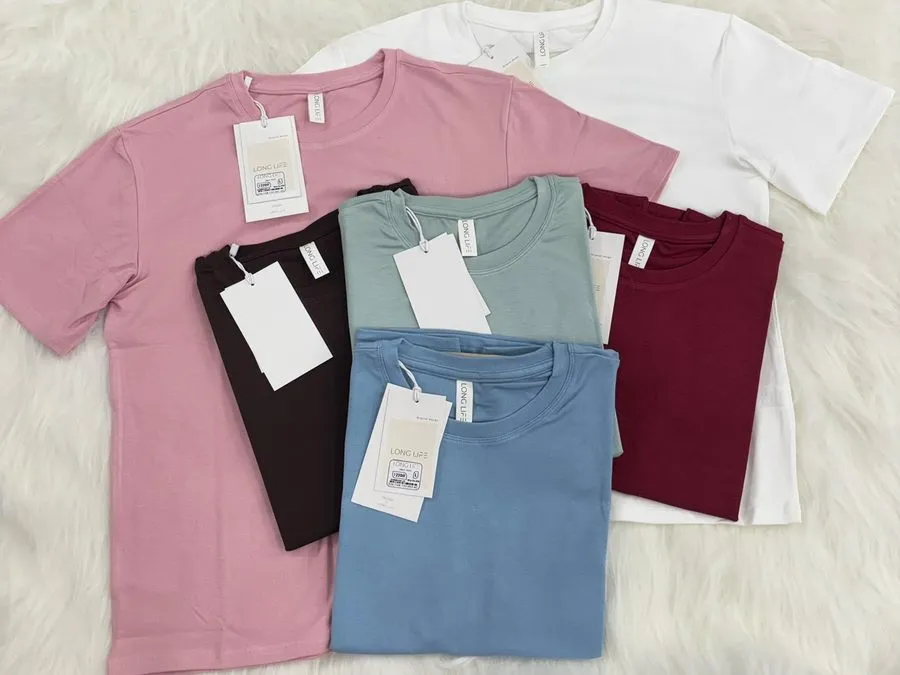 Folded private-label crew-neck t-shirts in several colours with hangtags